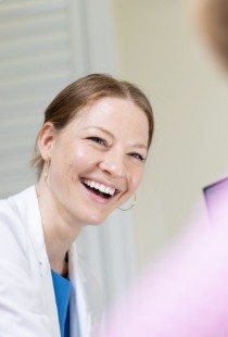 Doctor Bre smiling at dental patient