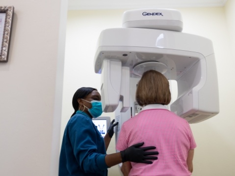Patient receiving 3 D C T cone beam x ray scans