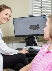 Dentist smiling at patient during complimentary consultation visit