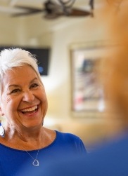 Woman smiling during custom-tailored dental exerpience