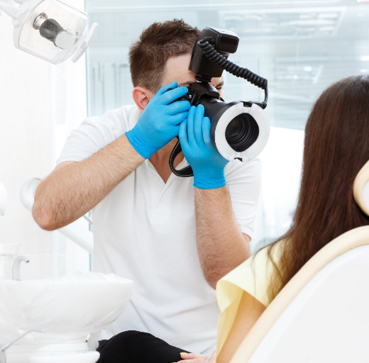 Dentist photographing patient after smile makeover in Bonita Springs