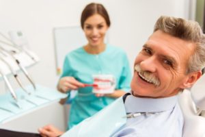 smiling man with implant dentures in Bonita Springs
